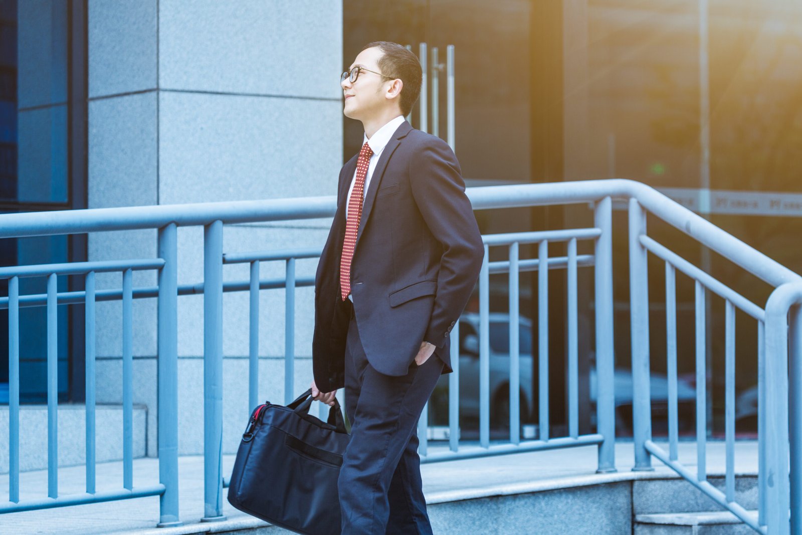 young businessman walking outside office